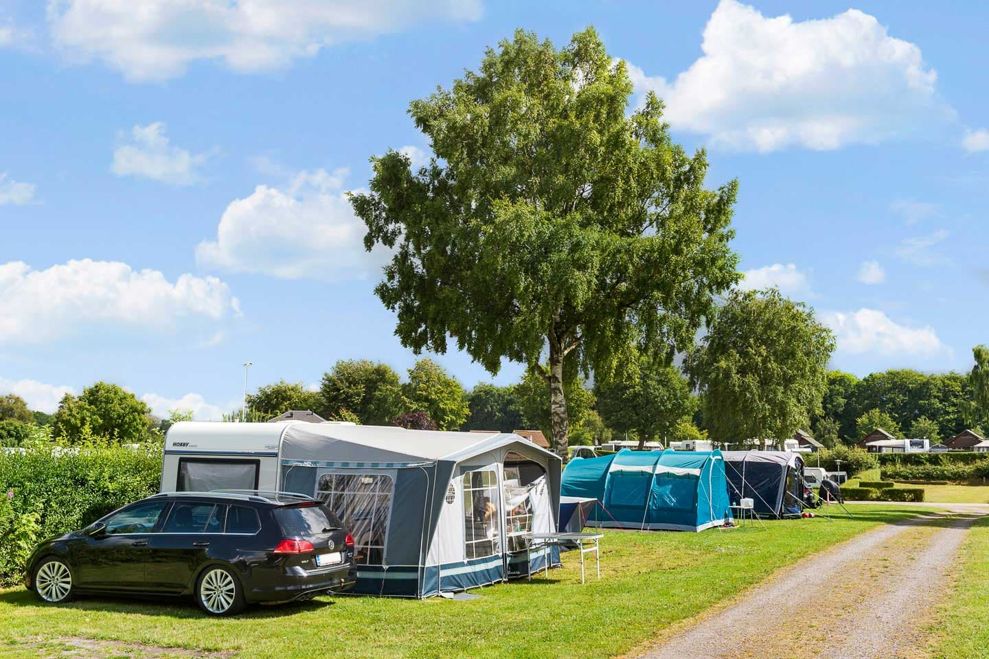Caravans and motorhomes parked on spacious camping pitches at First Camp Frigård