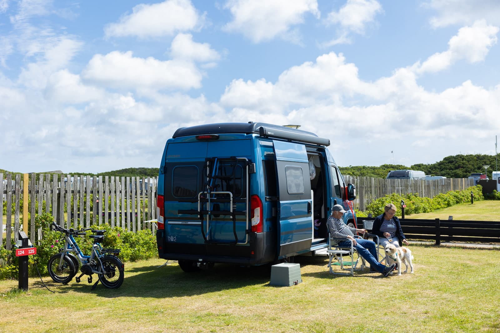 Caravans and motorhomes parked on sandy camping pitches near the beach in Skagen