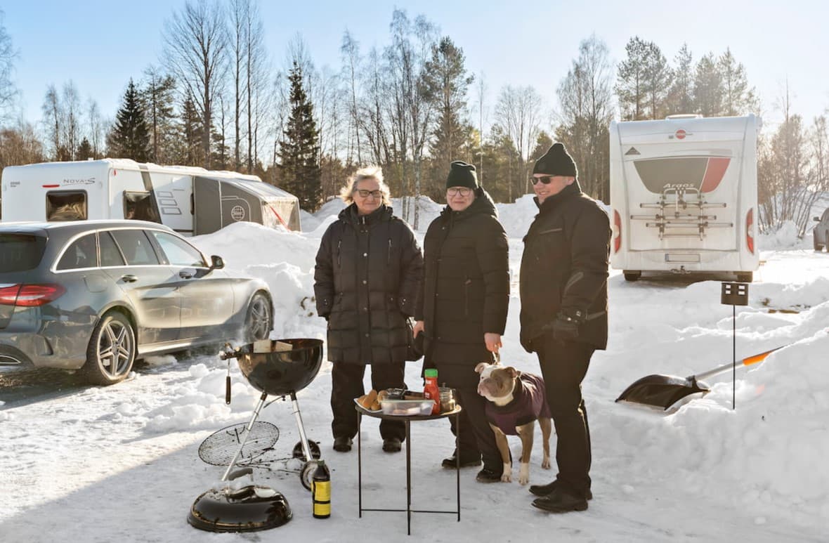 Dog walking in the snow at a First Camp dog-friendly campsite open year-round.